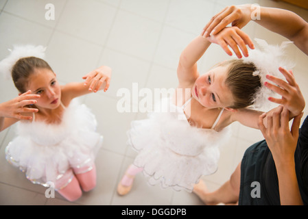 Mature ballet teacher arranging ballerina's hands Stock Photo