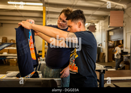 Workers checking quality in screen print workshop Stock Photo