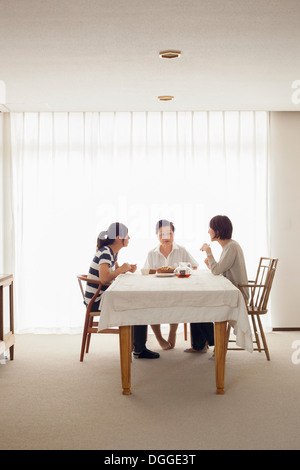 Three generation family at table Stock Photo