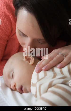 Mid adult woman kissing baby son, close up Stock Photo