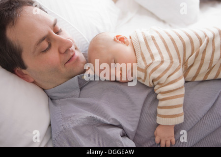 Mid adult man resting with son Stock Photo