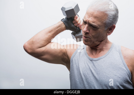 Senior man lifting dumbbell Stock Photo