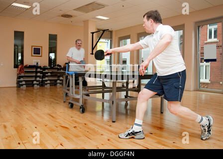 Two men playing ping pong Stock Photo