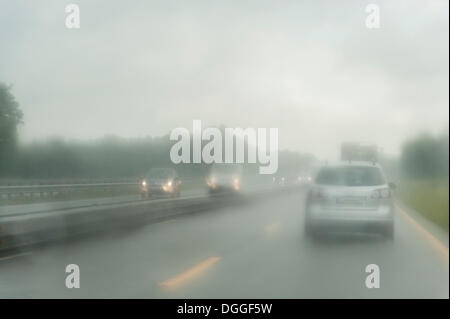 View through the windshield of a car driving on a highway in the rain, Lower Saxony