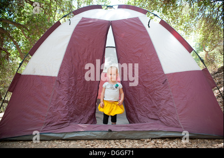 Young female toddler in tent doorway Stock Photo