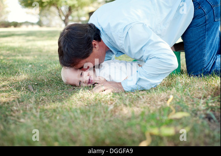 Grandfather having fun with grandson in park Stock Photo