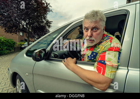 Car driver looking out of the car window angrily, Grevenbroich, Rhineland, North Rhine-Westphalia, Germany Stock Photo