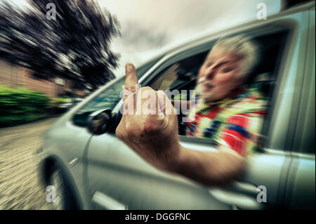 Car driver giving the finger, Grevenbroich, Rhineland, North Rhine-Westphalia, Germany Stock Photo