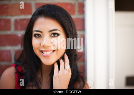 Close up portrait of young woman outside front door Stock Photo