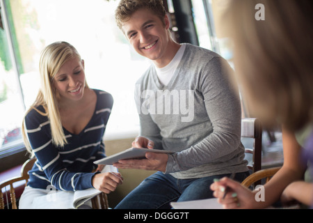 Small group of people studying together in cafe Stock Photo