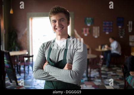 Portrait of young waiter in coffee house Stock Photo
