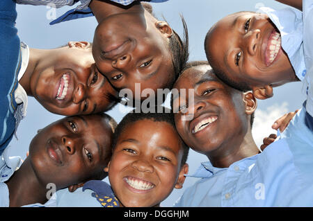 African children standing with their heads in a circle, Johannesburg, South Africa, Africa Stock Photo