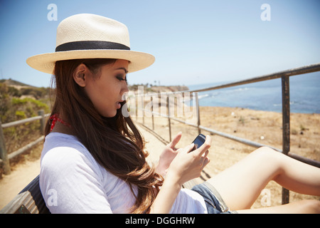 Young woman using cellphone, Palos Verdes, California, USA Stock Photo