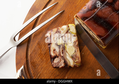 Still life with chopping board and sliced savory roulade Stock Photo