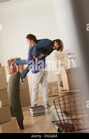 Couple having fooling about whilst moving Stock Photo