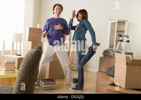 Couple having fun dancing whilst moving house Stock Photo