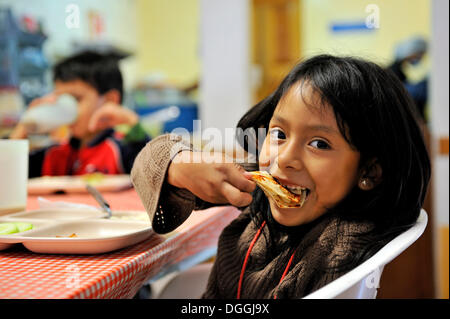 Girl eating a tortilla, Puebla, Mexico, Central America Stock Photo