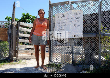 Woman standing in front of her house in a slum, she sells home made sweets to increase the family budget, Cancun Stock Photo