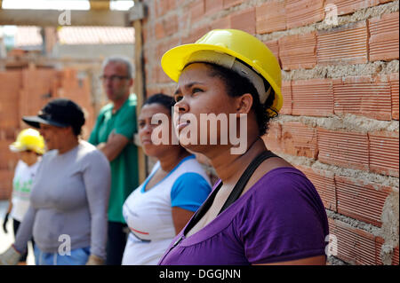 Young woman from the slums, favelas, on a building site of the "Esperanca" housing co-operative, each family helping out on the Stock Photo