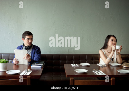Young man looking at young woman in restaurant Stock Photo