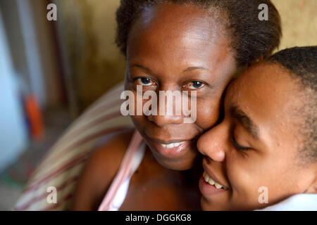 Boy hugging his mother in the slums, favela, Jacarezinho favela, Rio de Janeiro, Rio de Janeiro State, Brazil Stock Photo