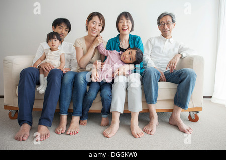 Three generation family sitting on sofa, portrait Stock Photo