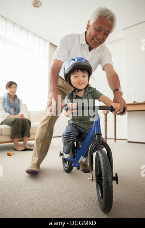 Boy learning to ride bicycle Stock Photo