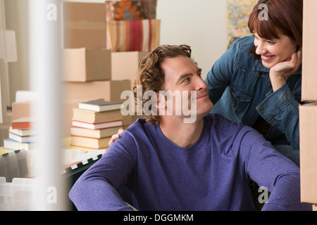 Couple surrounded by cardboard boxes