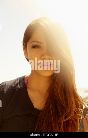 Portrait of smiling young woman at coast Stock Photo