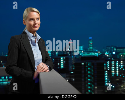 Smart lady in corporate environment overlooking the city Stock Photo