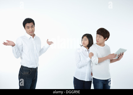 kids using tablet while father is looking Stock Photo