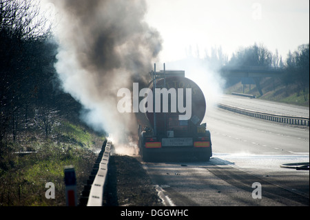 HGV Oil Tanker on Fire Motorway Hard Shoulder Stock Photo