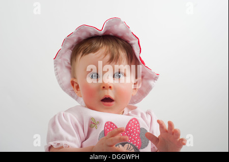 baby girl looking to camera wearing hat Stock Photo