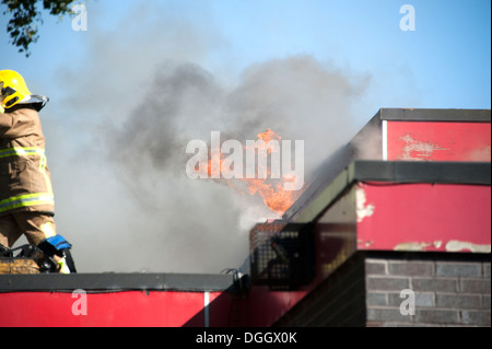 Flat roof bitumen on fire flames smoke safety risk Stock Photo - Alamy