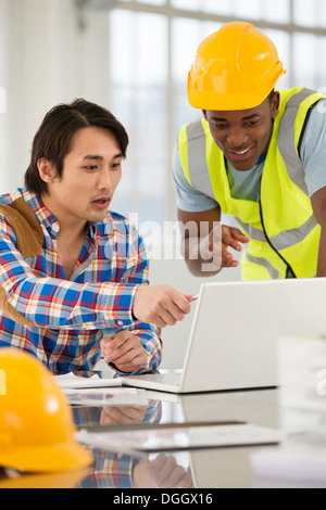 Two male engineers using laptop Stock Photo