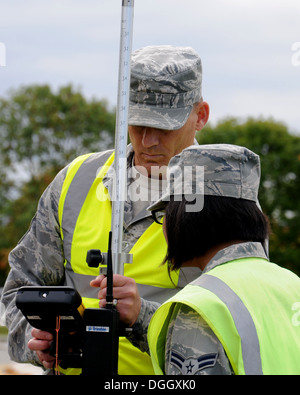 U.S. Air Force Chief Master Sgt. Tracy Jones, left, 100th Air Refueling Wing command chief, uses a geodimeter to map a new parking lot Oct. 9, 2013, on RAF Mildenhall, England. Members of the 100th ARW leadership visited the 100th Civil Engineer Squadron