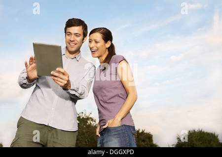 Mid adult couple using digital tablet Stock Photo