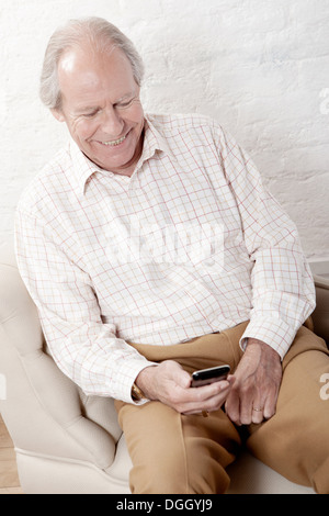 Senior man using smartphone Stock Photo