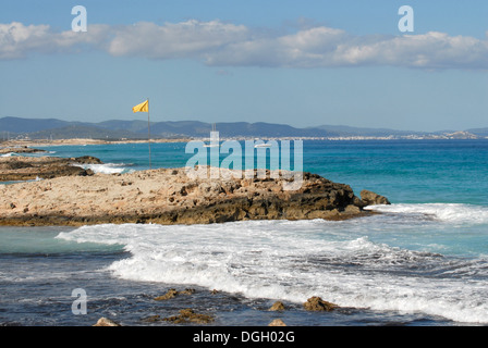 Strong sea and yellow flag in Levante beach - Playa de Llevant -, Formentera Stock Photo