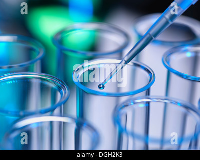 Analytical chemistry - sample being pipetted into test tube for ...
