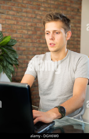 Young man working on laptop Stock Photo