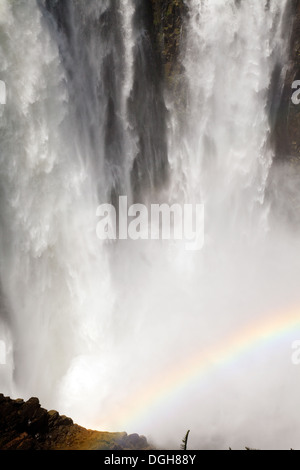 Torrent of water with rainbow, Victoria Falls waterfall seen from the Zimbabwe side, Africa Stock Photo