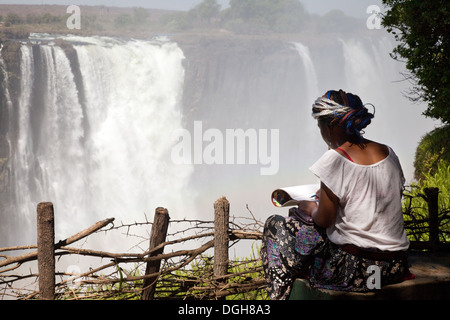 A local african teenager young woman drawing the Victoria Falls, Zimbabwe, Africa Stock Photo