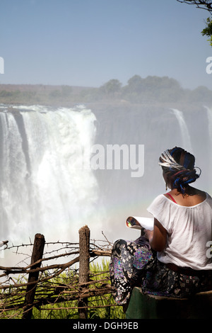 A local african teenager young woman drawing the Victoria Falls, Zimbabwe, Africa Stock Photo