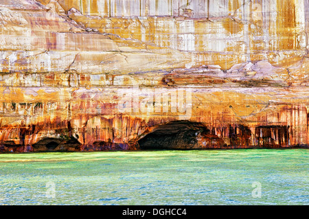 Naturally formed caves among the sandstone cliffs at Pictured Rocks National Lakeshore in Michigan's Upper Peninsula. Stock Photo