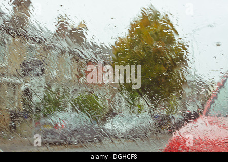 View of a street through a wet windscreen on a rainy day Stock Photo