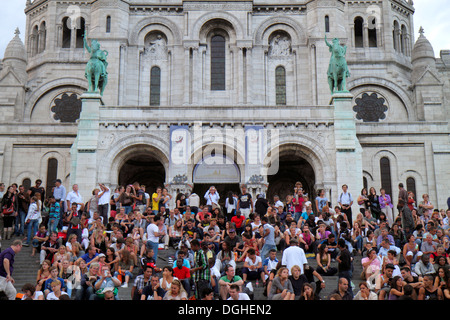 Paris France,18th arrondissement,Montmatre,Rue du Cardinal Dubois,La Basilique du Sacré-Coeur,Sacred Heart,Roman Catholic,church,crowd,sitting,steps s Stock Photo