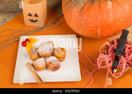 A traditional sweet Halloween dessert served with holiday decoration. Stock Photo