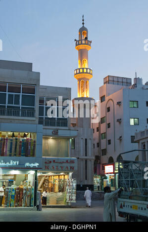 Street scene in old souq of Dubai with the minaret of a small mosque in the evening, Dubai, United Arab Emirates, Middle East Stock Photo