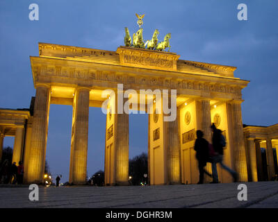 People walking in front of the Brandenburg Gate at dusk, Berlin Stock Photo